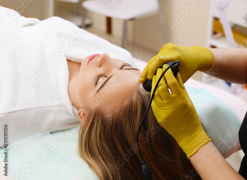 Woman visiting dermatologist at clinic.  photo