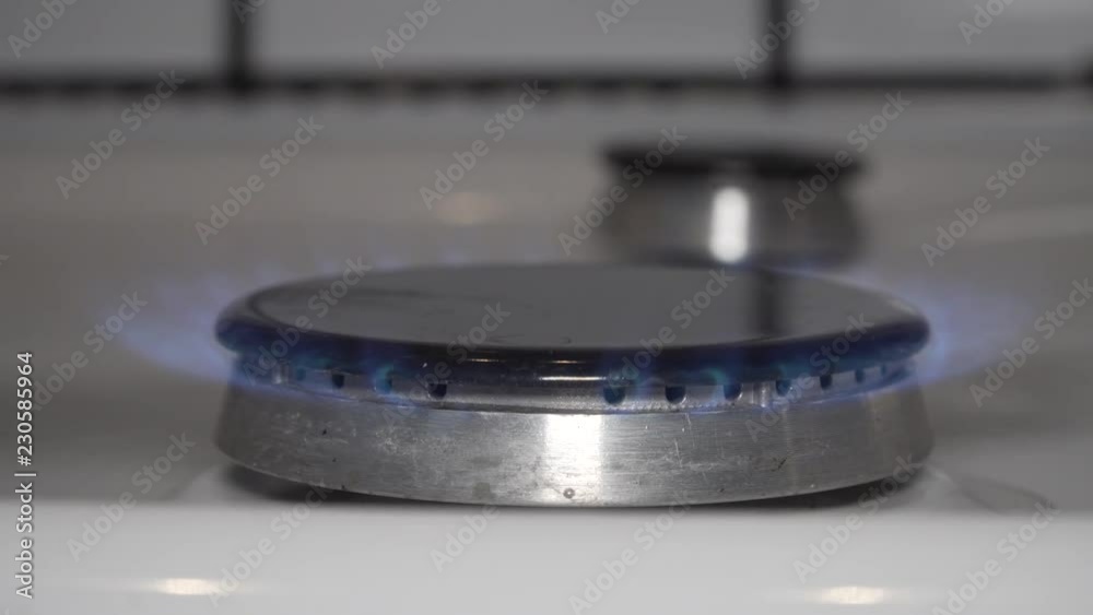 Gas stove burner lighting. Turning on gas burner Gas stove burner lighting. Turning on gas burner