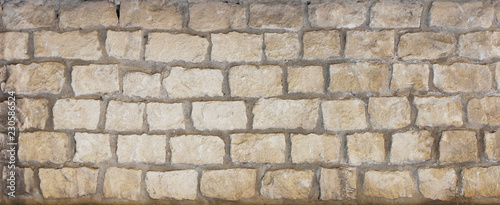 Old wall background from natural stones bricks and concrete. 