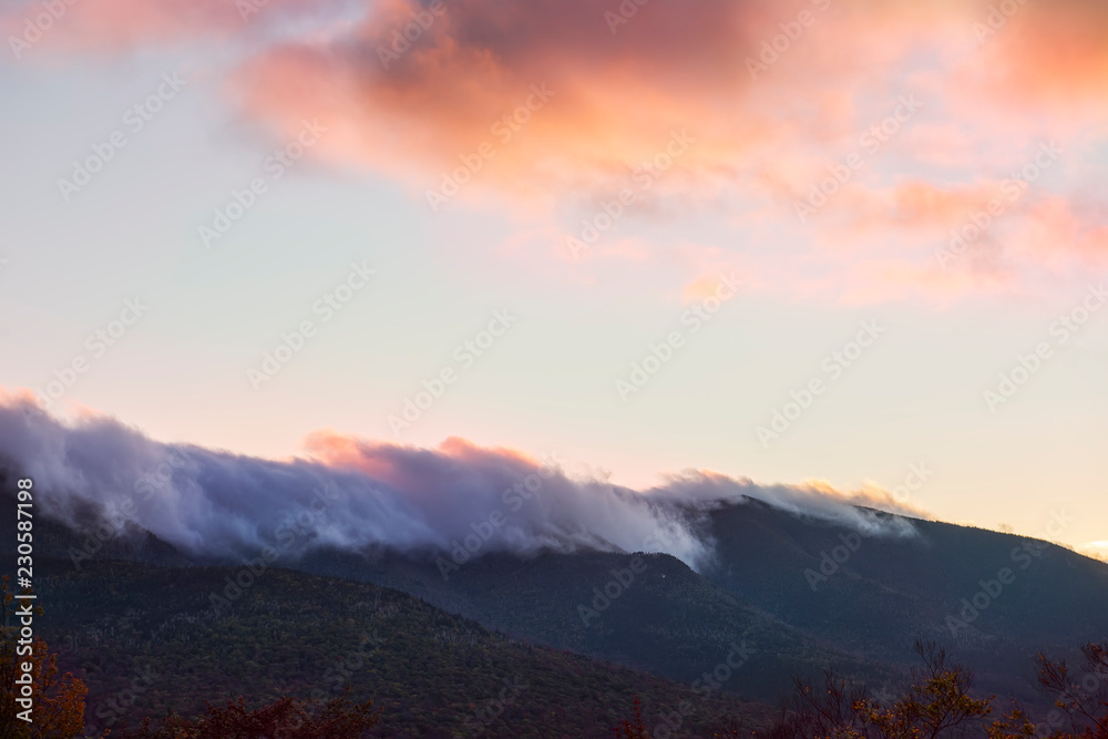 Peaks of green mountains in pink clouds at sunset. White Mountain National Park. USA. New Hamshire.
Peaks of green mountains in pink clouds at sunset. White Mountain National Park. USA. New Hamshire.