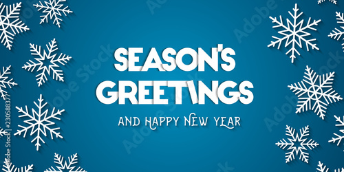 Season's Greetings and Happy New Year greeting card concept with white snowflakes and blue background photo