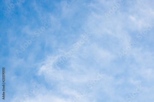 blue sky and white fluffy cloudy background .