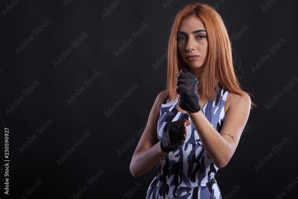 Karate girl doing taking front defense position. Combat sports.