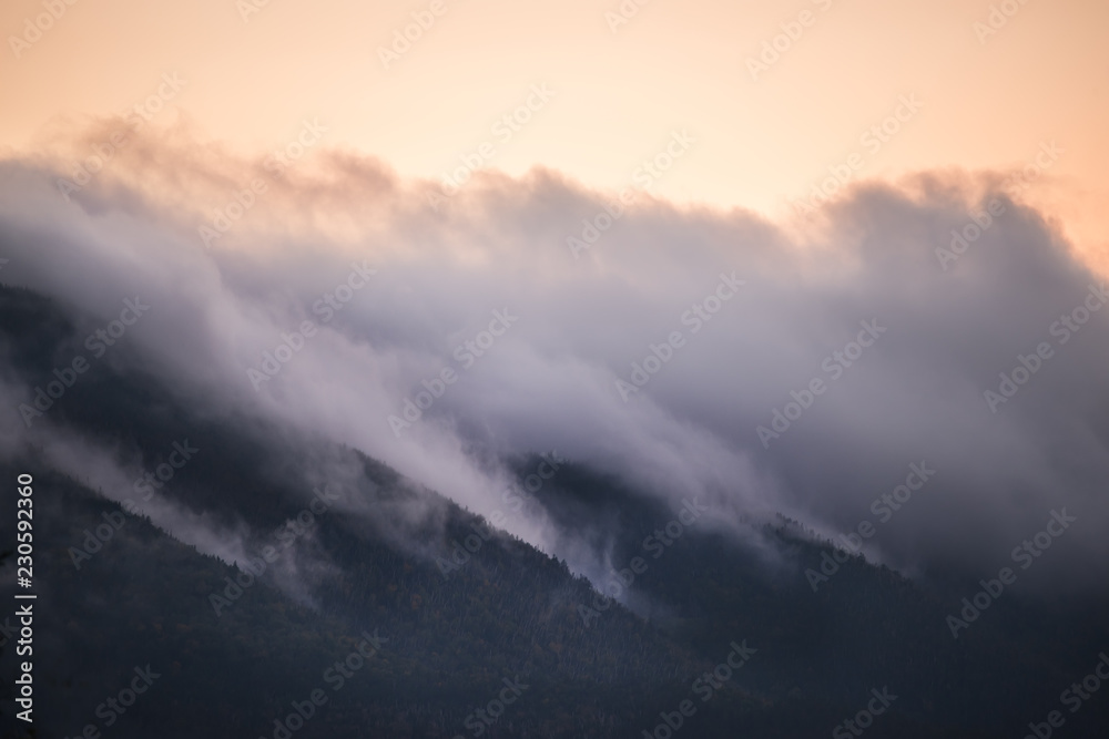 Peaks of green mountains in pink clouds at sunset. White Mountain National Park. USA. New Hamshire.
Peaks of green mountains in pink clouds at sunset. White Mountain National Park. USA. New Hamshire.