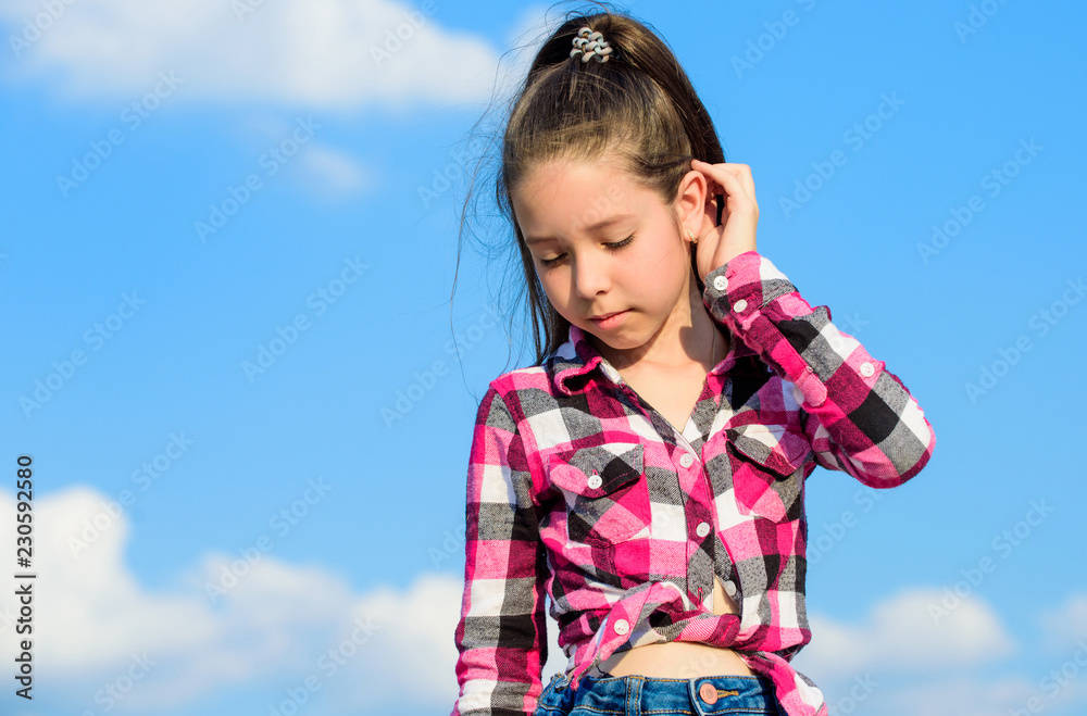 Fashion model girl. Stylish fashionable kid. Kids fashion concept. Kid girl checkered fashionable shirt posing sunny day blue sky background. Child cute girl long hair ponytail hair Fashion model girl. Stylish fashionable kid. Kids fashion concept. Kid girl checkered fashionable shirt posing sunny day blue sky background. Child cute girl long hair ponytail hair