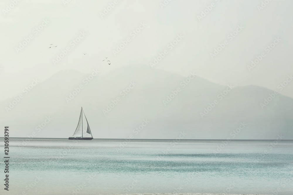 Fototapeta sailboat glides lightly on the waves of a pristine ocean