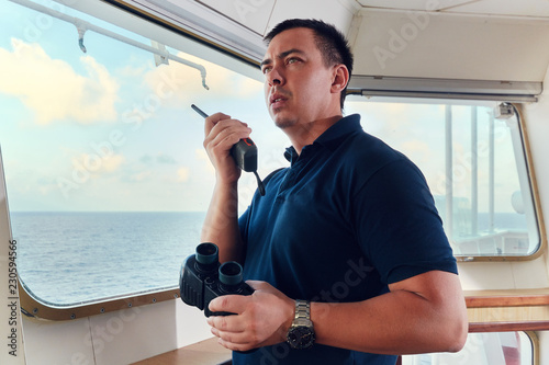 Portrait of navigator / pilot / officer on the bridge of the vessel Fototapete