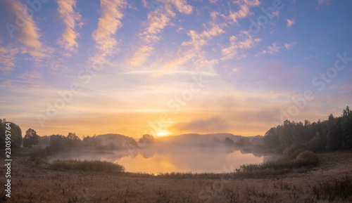 Beautiful misty sunrise over the lake