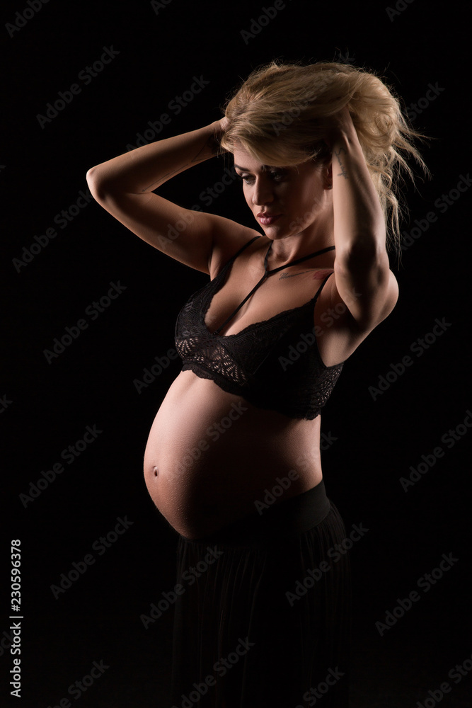 portrait of a pregnant woman in a dark background
