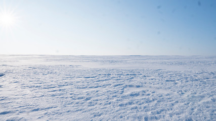 A Field covered with a snow in winter season. Winter countryside landscape.