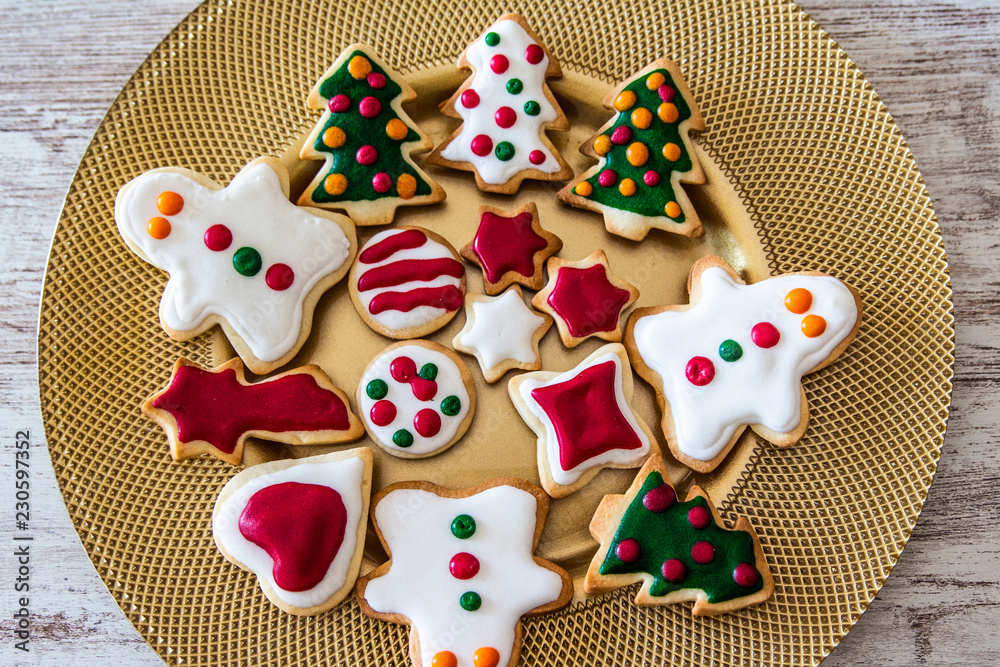 Christmas cookies on a dish with a wooden table background