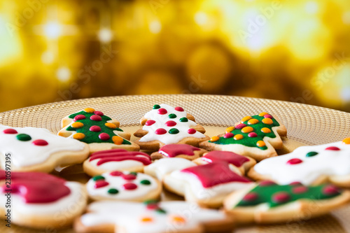 Christmas cookies on a dish with golden lights background