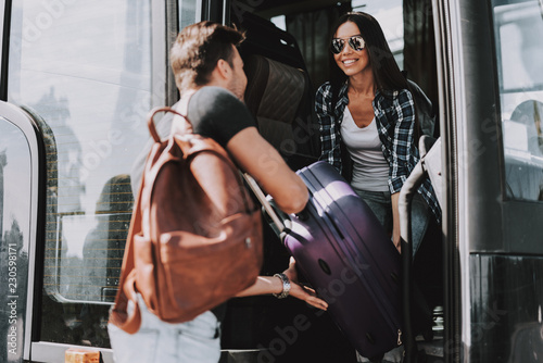 Smiling Young couple Boarding on Travel Bus