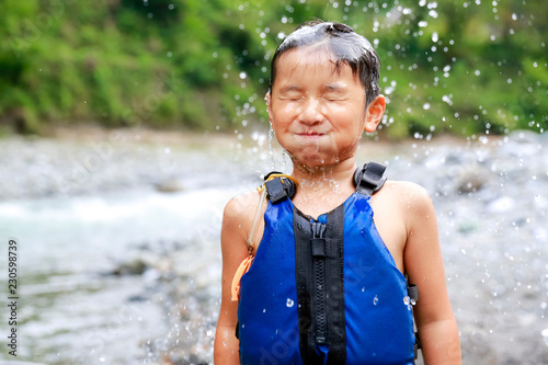 Boy been splashed by water photo