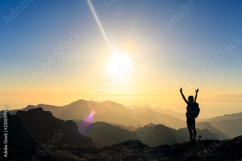 Woman hiking success silhouette in mountains sunset photo