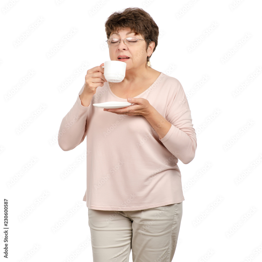 Beautiful woman aged with glasses in hand a cup and saucer tea coffee on white background. Isolation Beautiful woman aged with glasses in hand a cup and saucer tea coffee on white background. Isolation