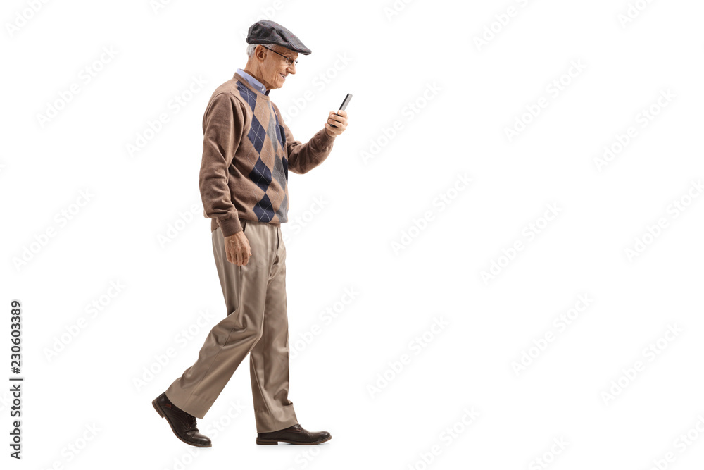 Senior man walking and using a mobile phone Senior man walking and using a mobile phone