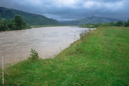 Beautiful mountain river in cloudy weather in the European Chati world. The flood of rain. Stock photo for design