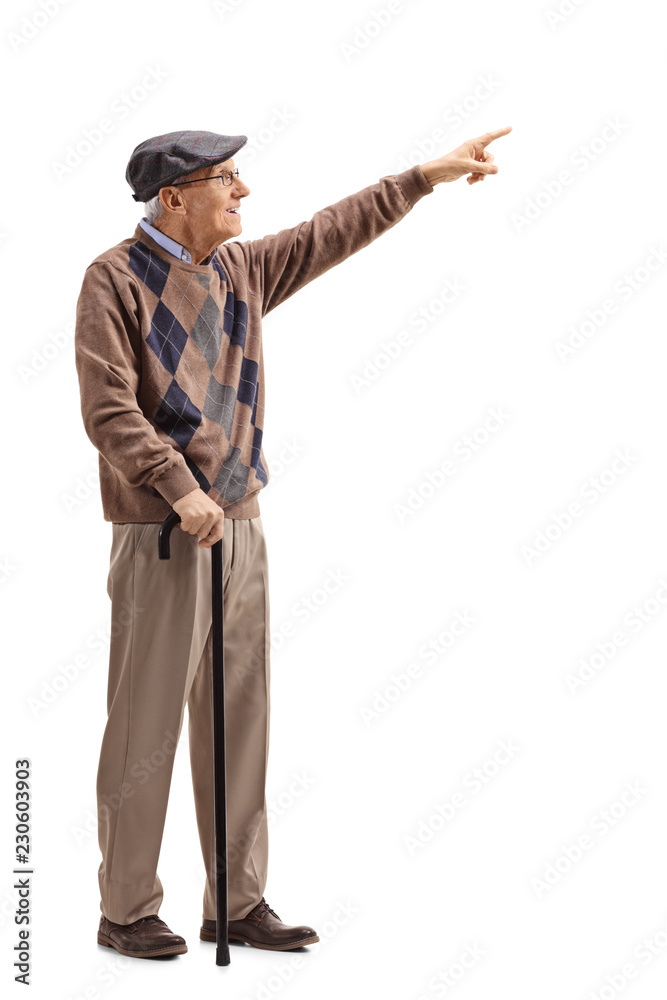 Elderly man standing with a cane and pointing Elderly man standing with a cane and pointing
