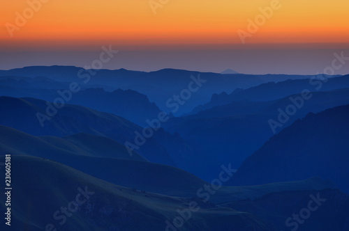 Fototapeta Naklejka Na Ścianę i Meble -  Early morning in the mountain area. Dawn over the mountains and valleys of the North Caucasus in Russia.