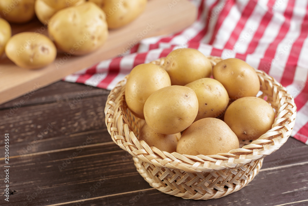 Fresh potatoes on the wood background Fresh potatoes on the wood background