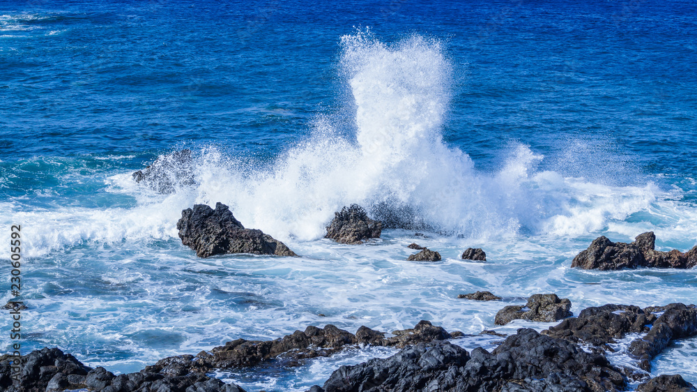 Fototapeta premium Waves Crashing over Rocks showing Spray and White Foam La Palma Canary Islands Spain