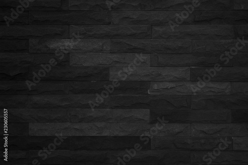 Seamless Black pattern of decorative brick sandstone wall surface with concrete of modern style design decorative uneven have cracked realmasonry wall of multicolored stones or blocks with cement.