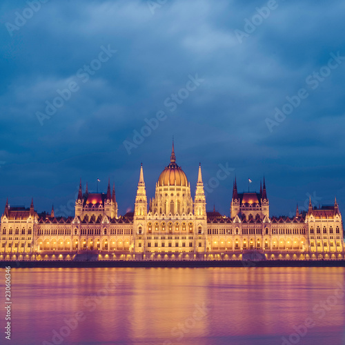 Night view of the illuminated building of the hungarian parliament in Budapest. A beautiful reflection of the parliament building on the Danube River. Winter city night landscape.