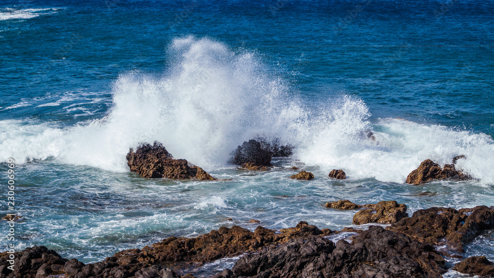 Waves Crashing over Rocks showing Spray and White Foam La Palma Canary Islands Spain