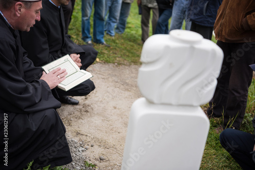 quran holy book reading by imam  on islamic funeral photo