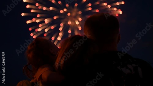 Friendly family with a daughter in their hands are watching salute. slow motion, 1920x1080, full hd