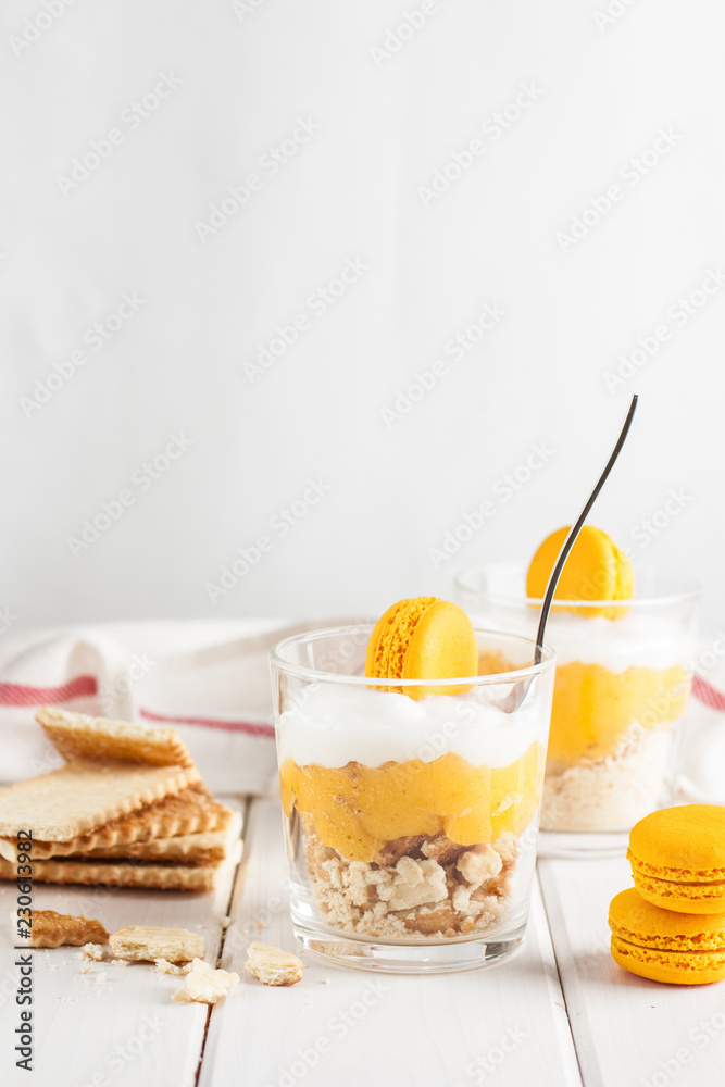 Lemon souce, mascarpone cream cheese and biscuit. Layered dessert in glass. Lemon souce, mascarpone cream cheese and biscuit. Layered dessert in glass.