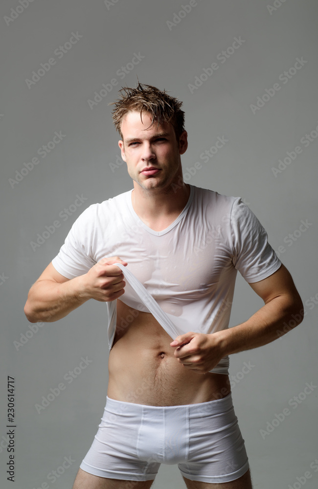 Underwear. Sexy guy take off wet shirt. Sexy guy in wet white shirt. Man in  white underwear. Man in underwear isolated. Black Friday. Men in boxer  shorts. Fitness model. Sale. Discount. Stock