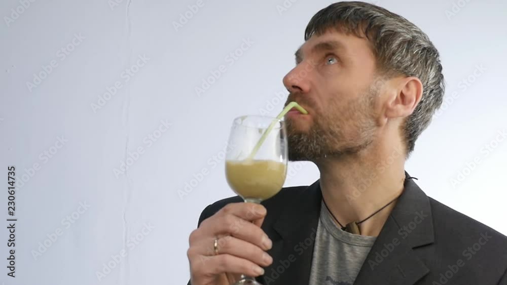 bearded man drinks cocktail from vegetable and fruit. detox smoothie, healthy lifestyle concept. slow motion bearded man drinks cocktail from vegetable and fruit. detox smoothie, healthy lifestyle concept. slow motion