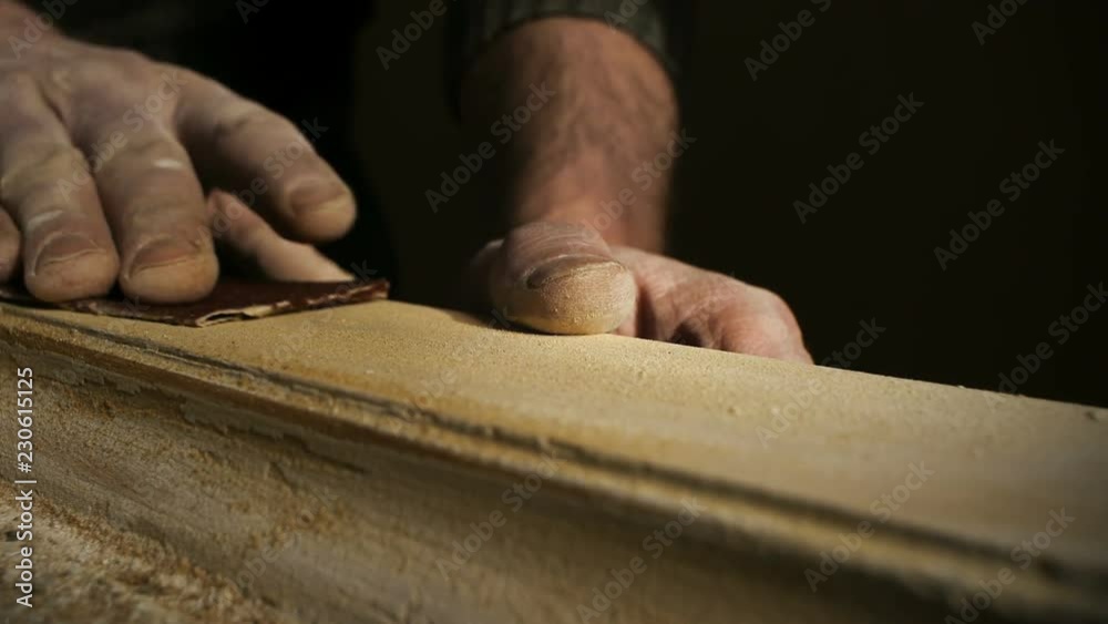 Artisan hands restoring wooden window