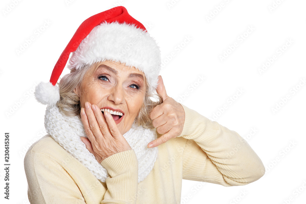 Portrait of beautiful senior woman in Santa hat showing call me Portrait of beautiful senior woman in Santa hat showing call me