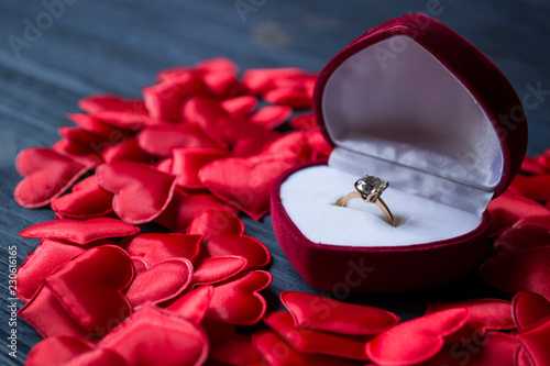 Engagement ring in a red box on a love hearts background. Valentine's day 2019. © Natali Vinokurova