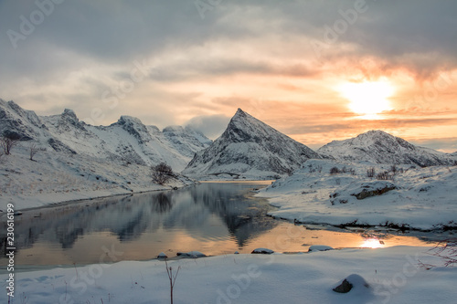 Norwegian Fjord among Winter Mountains at Sunset