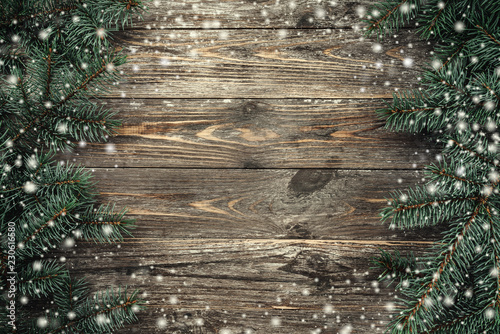 Wallpaper Mural Old wood background with fir branches. Space for a greeting message. Christmas card. Top view. Effect snowflakes. Torontodigital.ca