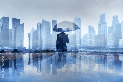 insurance concept, risk in business, businessman with umbrella double exposure photo