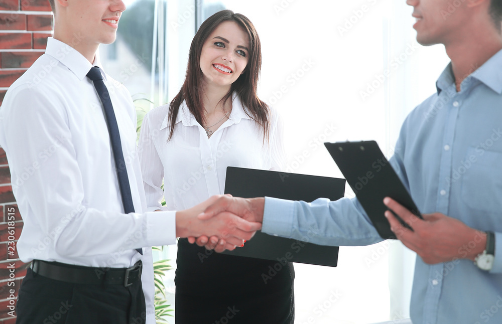 handshake of young business partners in the office handshake of young business partners in the office