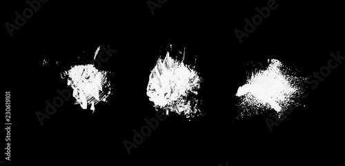 three white abstract paint strokes isolated on black surface isolated f