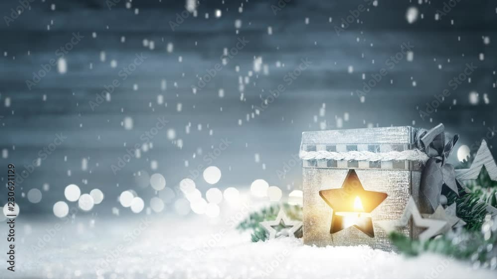 Christmas scene with wood board, lantern, fir branches, lights and falling snow