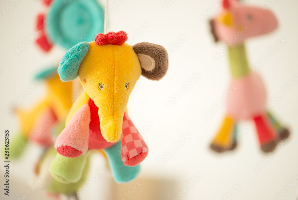 Carousel of children's soft colored toys.