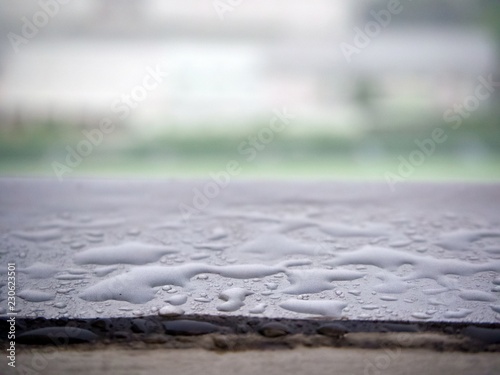 Droplets of water on the corridor edge that can be see after the rain with blur background