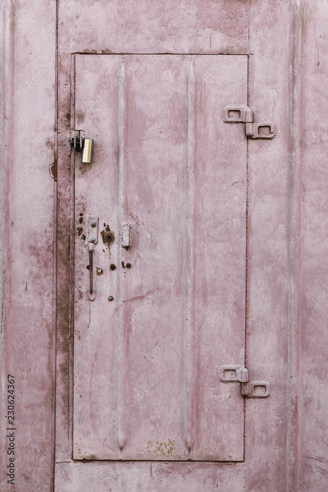 Texture of the surface of a rusty metal garage with cracked paint