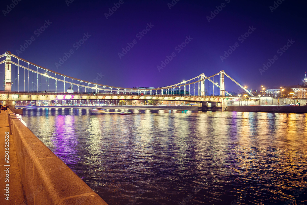 The long beautiful bridge across the river in the evening.