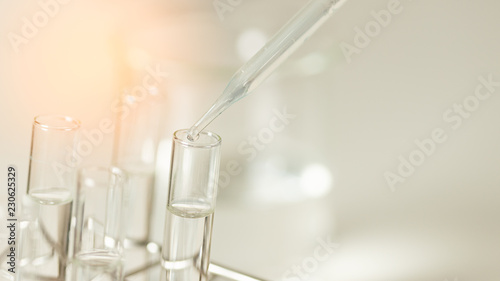 Dropping chemical liquid to test tube, laboratory research and development concept. scientist sample chemistry or medicine test