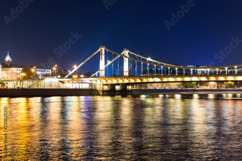 The long beautiful bridge across the river in the evening.