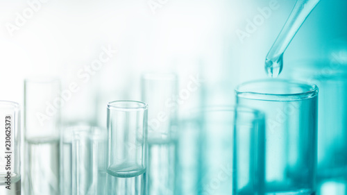 Dropping chemical liquid to test tube, laboratory research and development concept. scientist sample chemistry or medicine test
